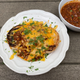 Can you spot the burger and the bun somewhere in this dish?